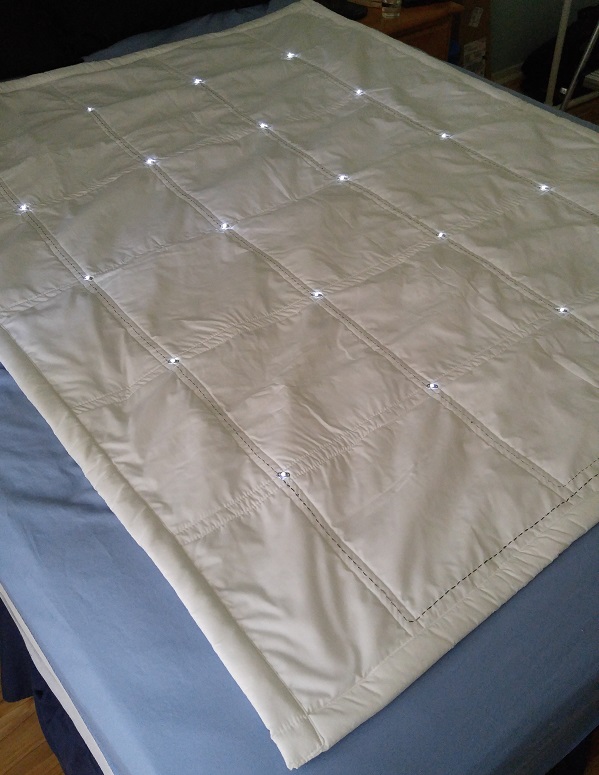 Image of White-on-White Grid quilt on bed